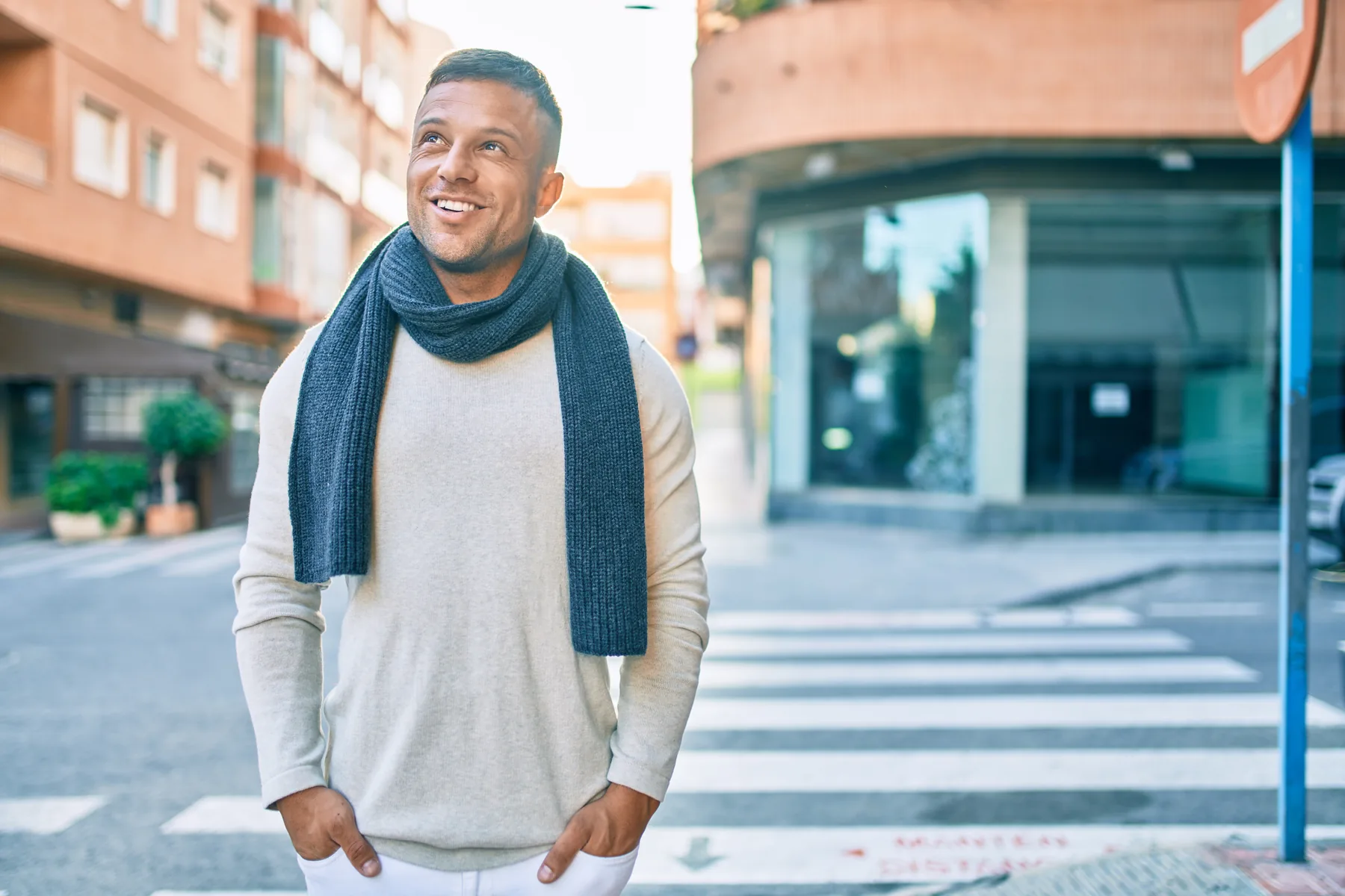 Smiling man walking on a city street
