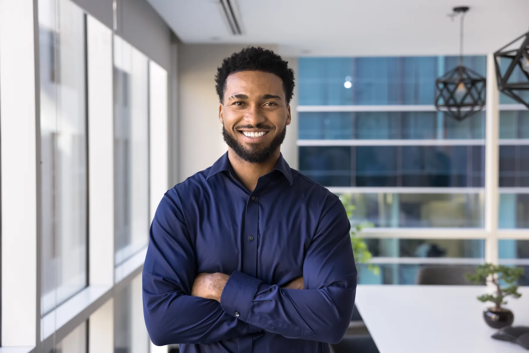 Smiling man standing in a modern office