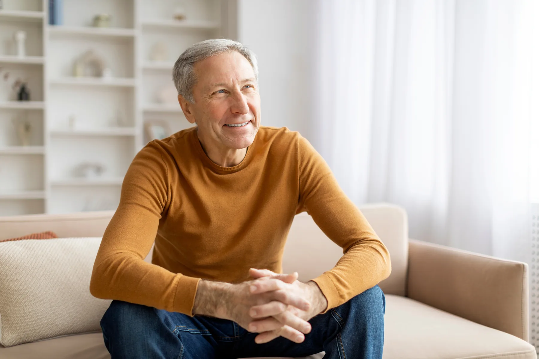 Smiling senior man sitting on a couch